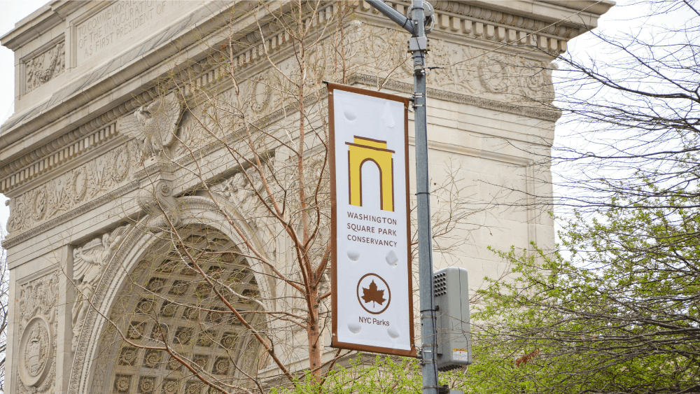 A Washington Square Park Conservancy banner.