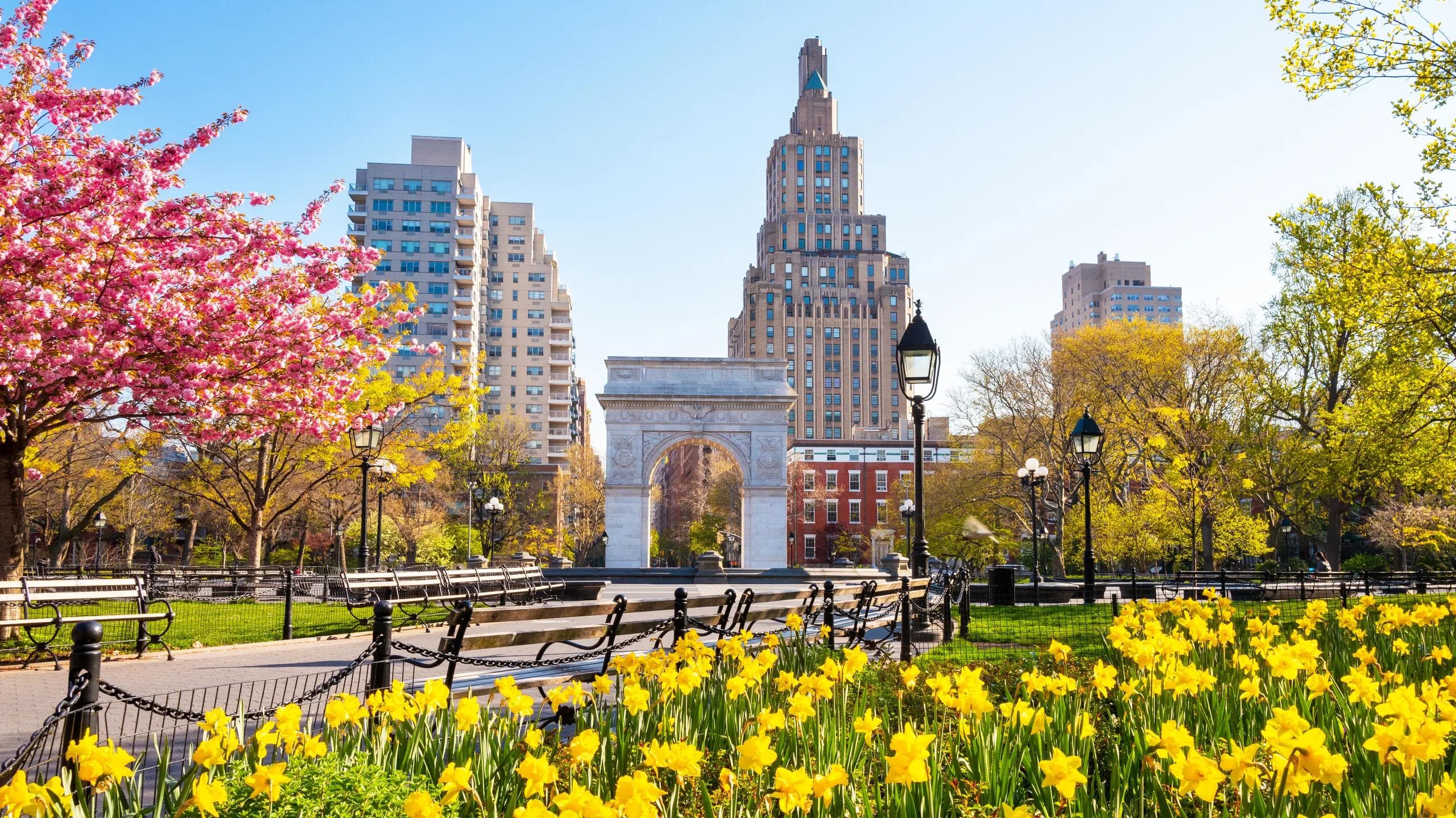 Spring flowers, benches, and the Washington Square Arch.
