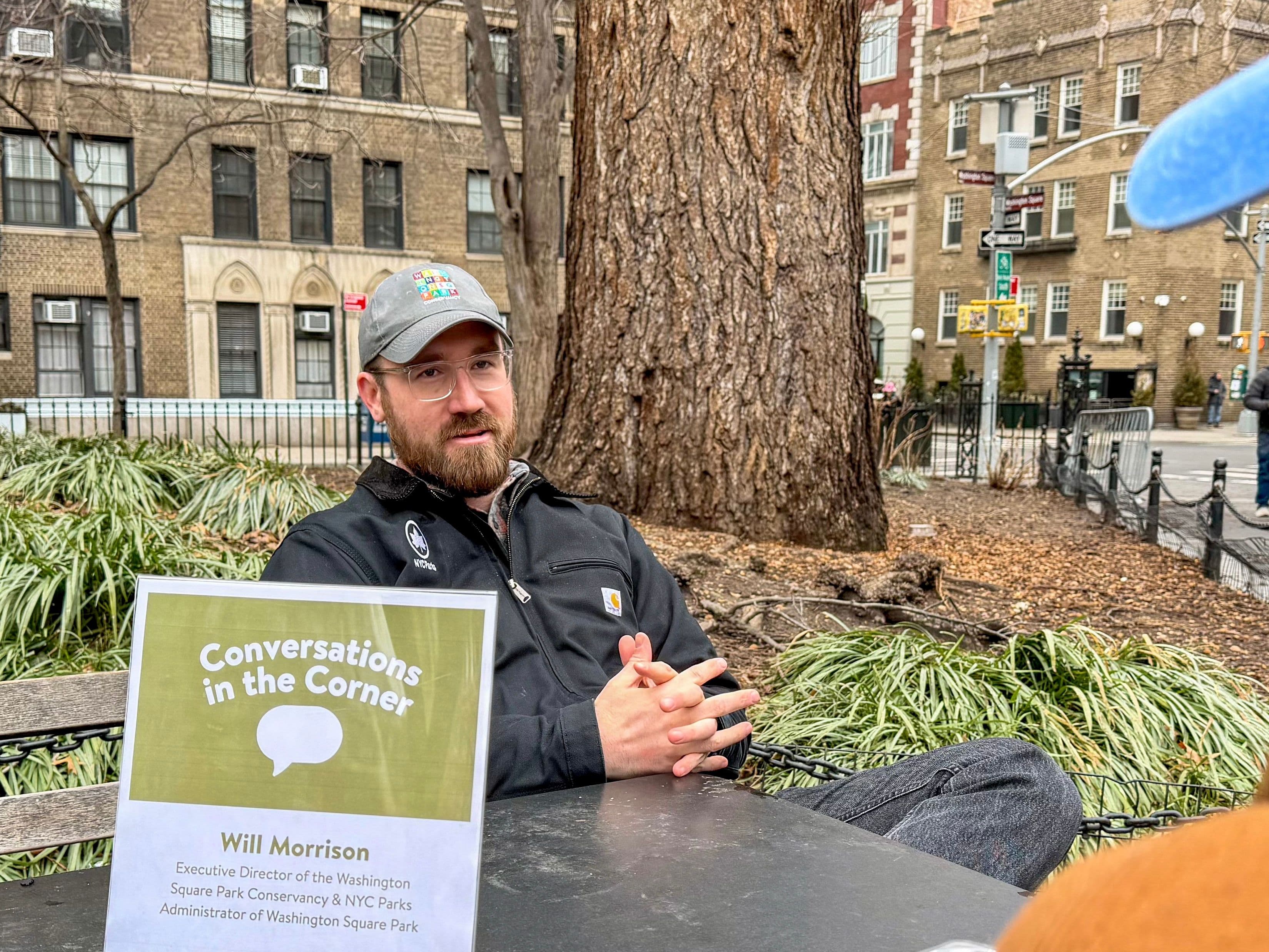Will Morrison, Executive Director of the Washington Square Park Conservancy & NYC Parks Administrator of Washington Square Park, speaks to a community member in Scrabble Plaza in Washington Square Park.