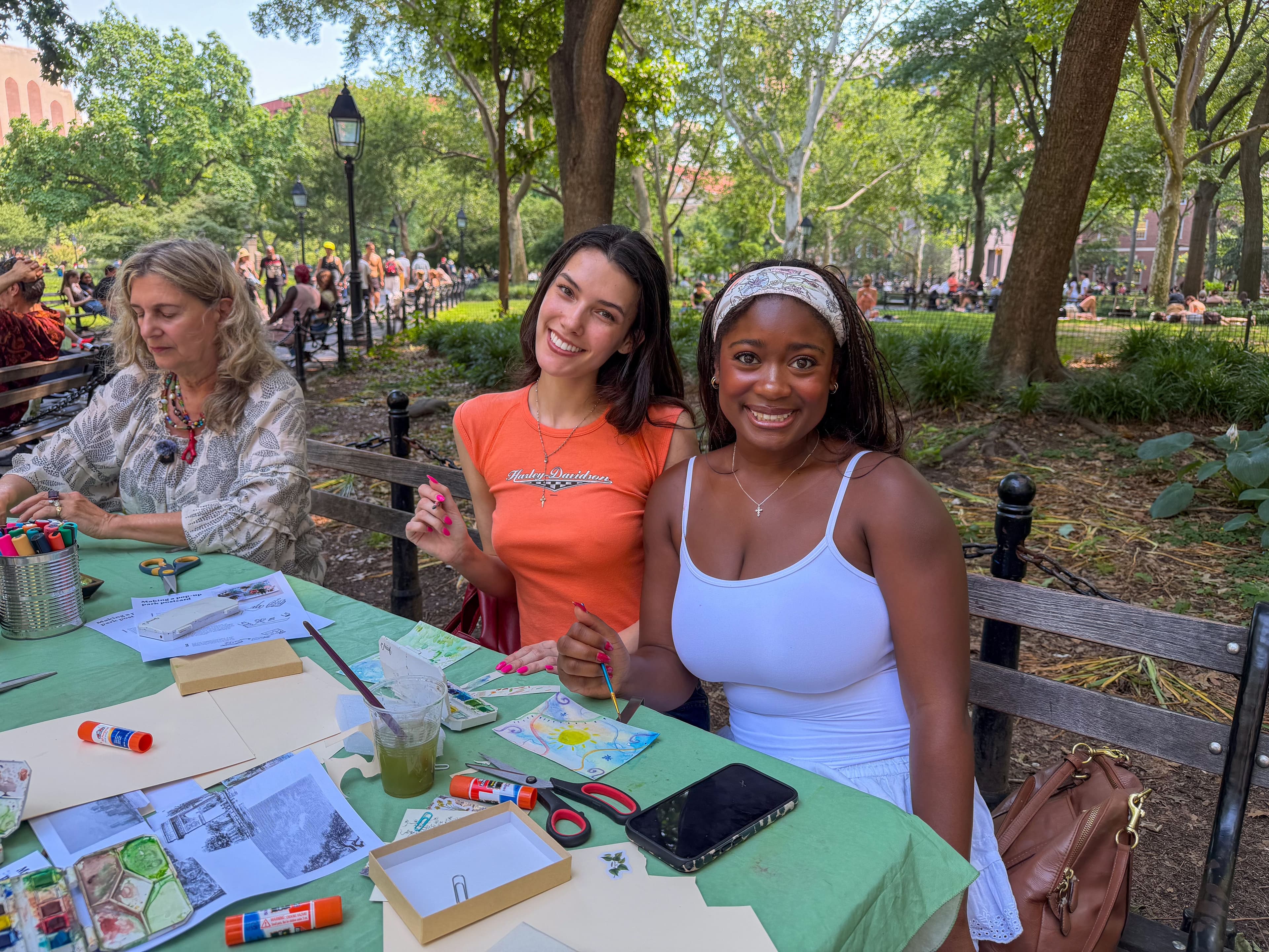 People pose while creating art in Washington Square Park.