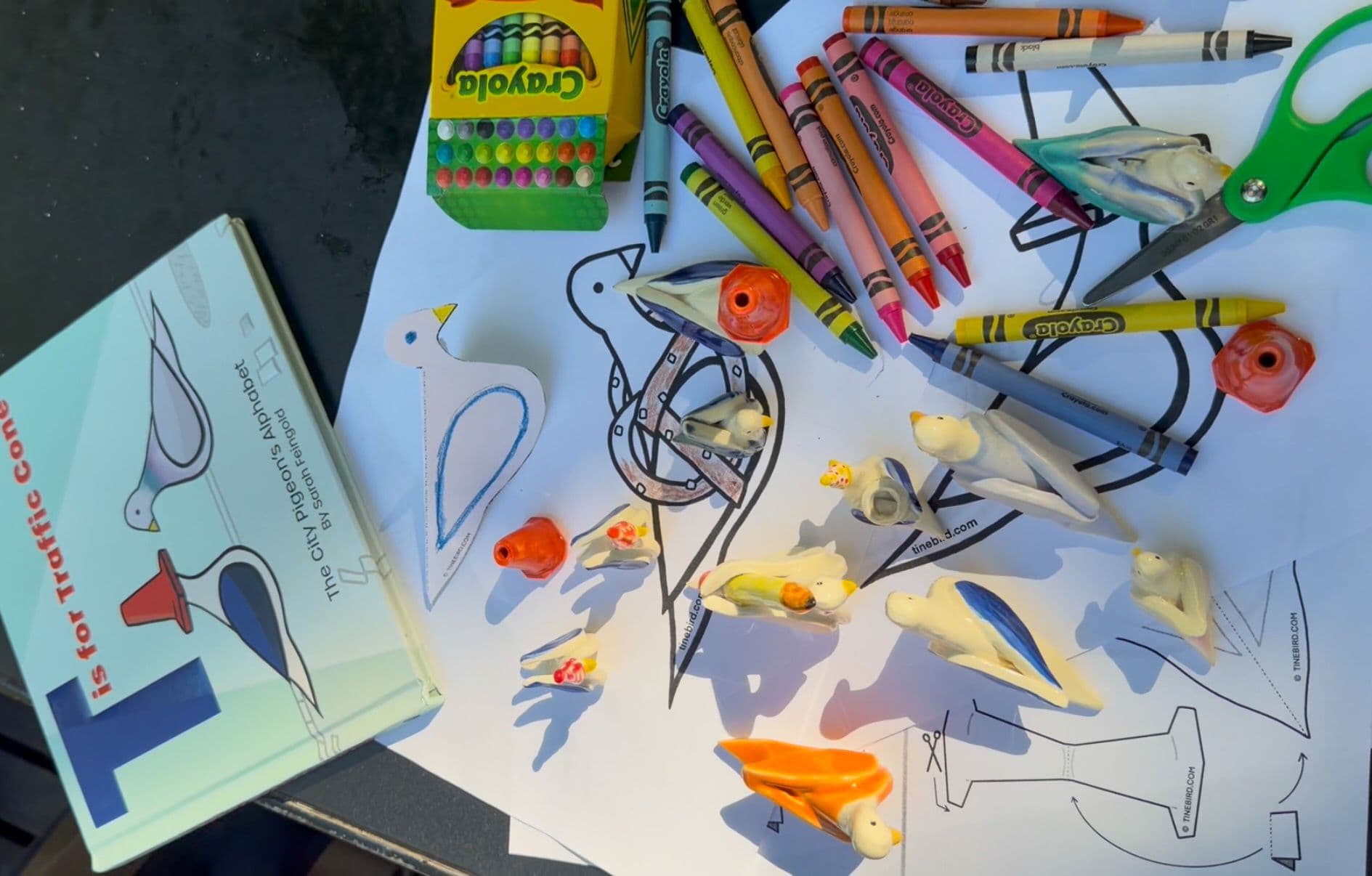 Pigeons crafts, crafts, and supplies on a table.