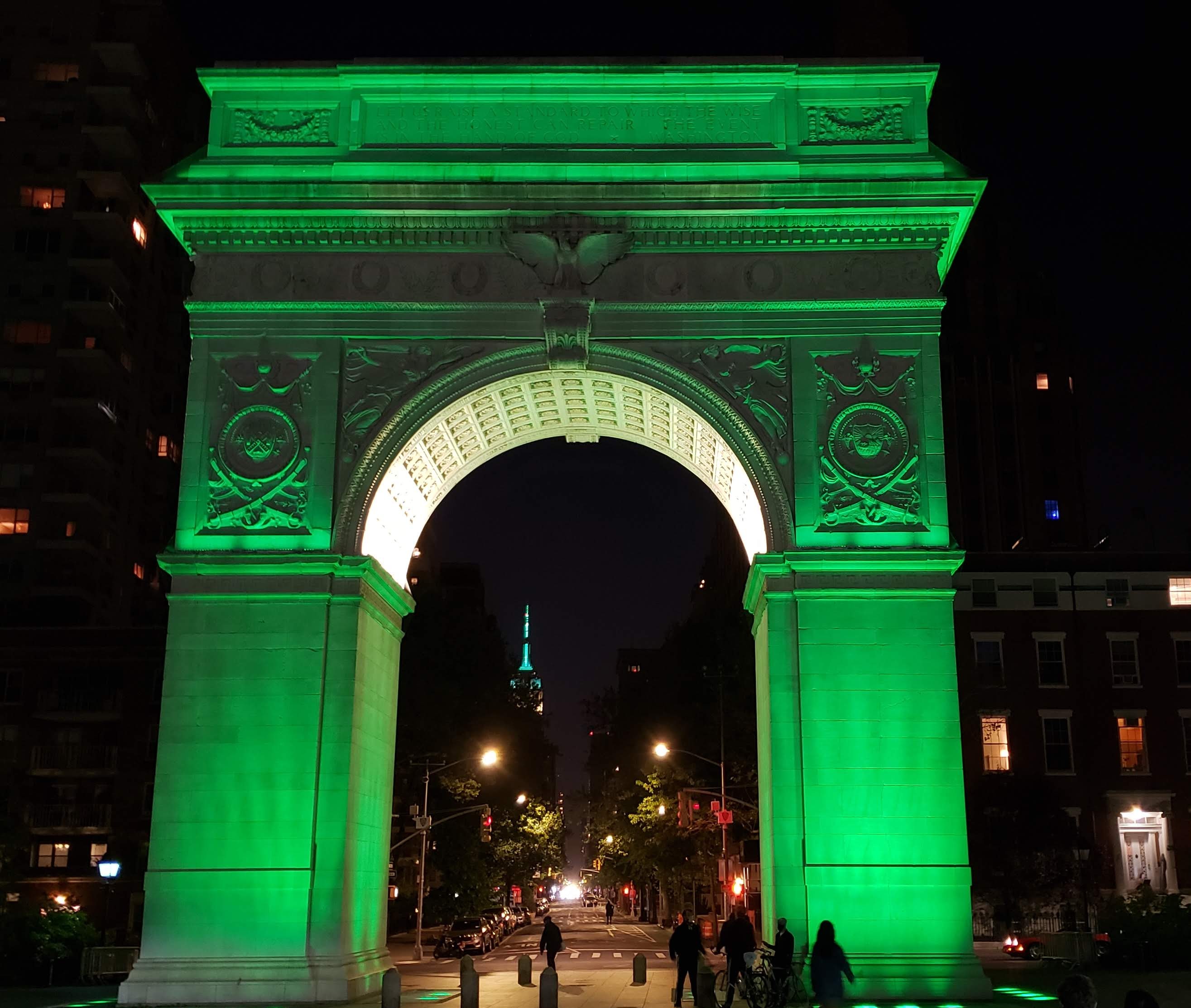 the arch at night illuminated with green lights