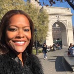 a selfie of washington square park conservancy board member, Lydia, smiling in front of the arch