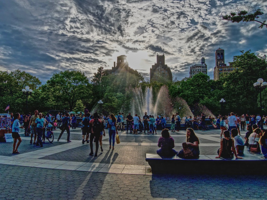 a crowded day at the park fountain