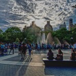 a crowded day at the park fountain