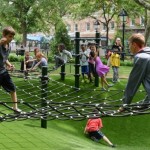 children playing on a climbing net in the small playground