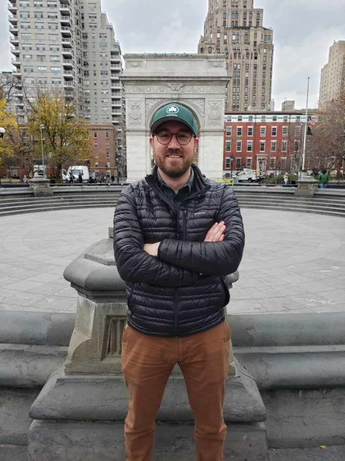 Deputy Administrator Will stands in front of the Arch and Fountain 