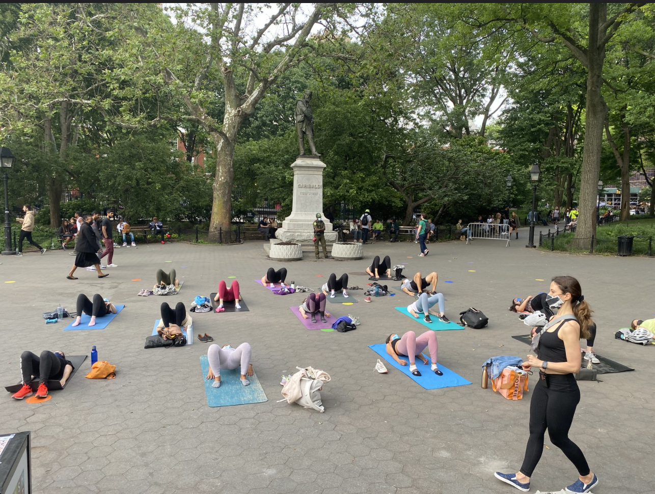 people exercising in garibaldi plaza on yoga mats
