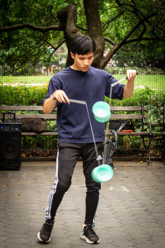 a person playing with a diablo yo yo in the park