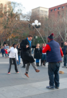 image of a man in midair while jumping double dutch while a crowd watches