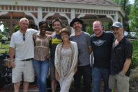 members of the band Tycoon Dog smile for the camera in front of a gazebo