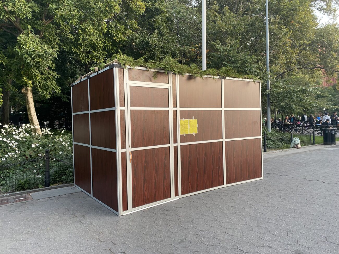 Washington Square Park's Sukkah: a rectangular construction with brown walls and a green roof
